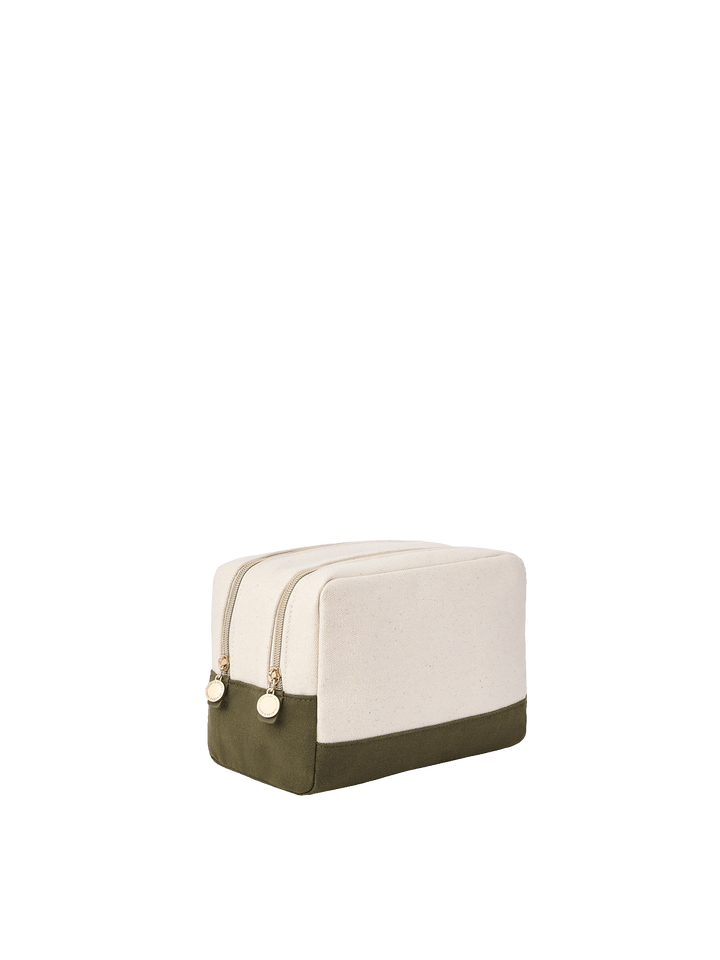 Poppy & Peonies The Double Take Cosmetic in Olive, angled side view showing the cream upper exterior, olive green base, and two gold-tone zippered compartments.