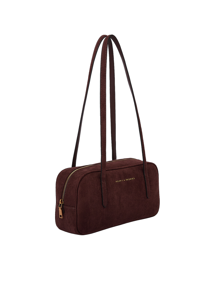 Poppy & Peonies The Friday Satchel in Espresso Suede angled side view, highlighting the slim structured shape, long shoulder straps and gold-tone zipper hardware.