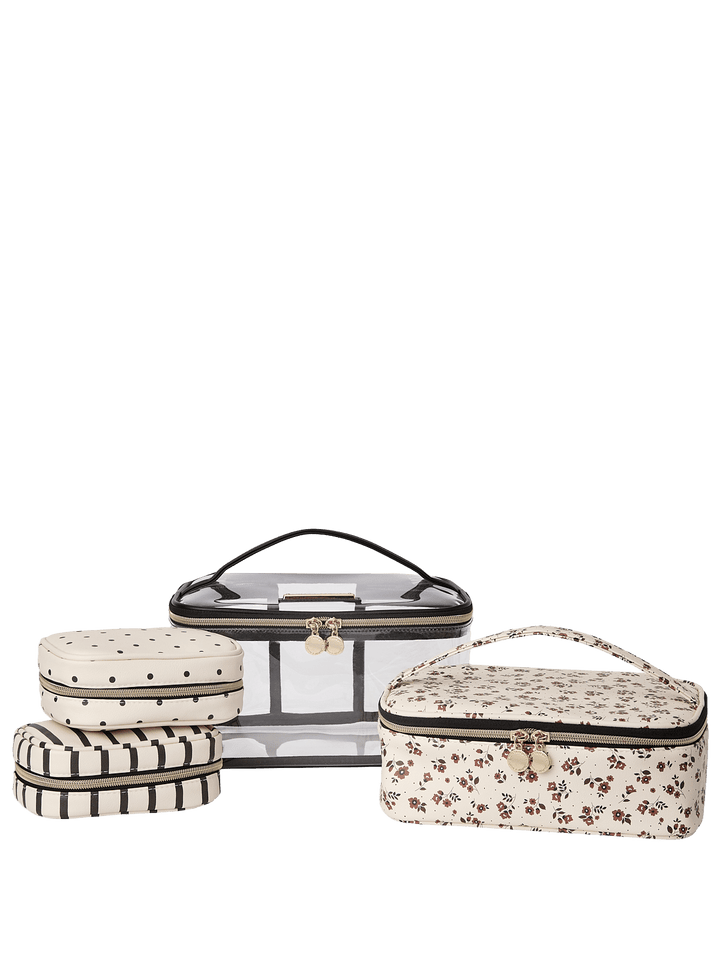 Set of four travel cases with floral and polka dot patterns on a white background