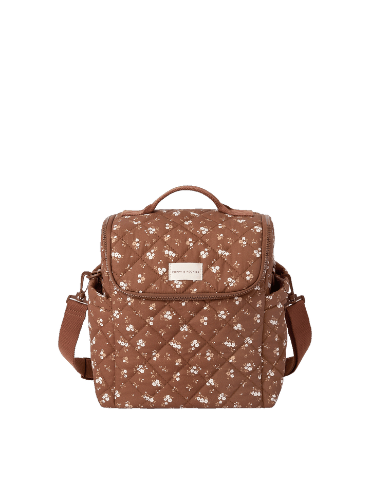 Poppy & Peonies The Lunch Date in Brown Floral with top handle, front flap, side pockets, and adjustable shoulder strap.