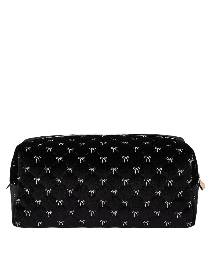 Poppy and Peonies The Mane Character Case Black Velvet displayed from the back, featuring its soft black velvet exterior with delicate white bow patterns, structured rectangular silhouette, rounded edges, and zippered top closure.