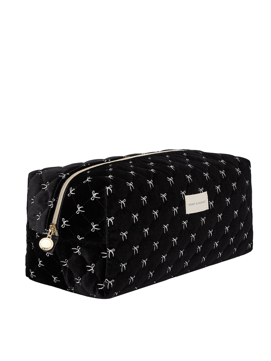 Poppy and Peonies The Mane Character Case Black Velvet displayed at a three-quarter angle, highlighting its structured rectangular shape, soft black velvet exterior with white bow patterns, rounded edges, gold-tone zipper hardware, and spacious side profile.