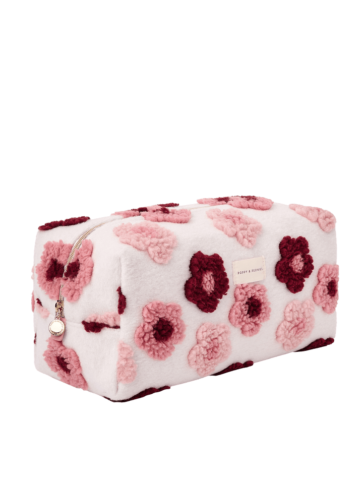 Poppy and Peonies The Mane Character Case Floral displayed at a three-quarter angle, highlighting its structured rectangular shape, soft cream-colored exterior with raised pink and berry floral patterns, rounded edges, and spacious side profile.