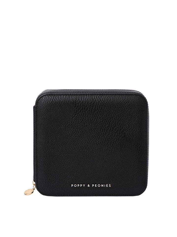 Poppy and Peonies The Out of Office Case Black featuring a compact square silhouette, textured black exterior, rounded corners, gold-tone zipper closure with round zipper pull, and gold Poppy and Peonies logo near the bottom.