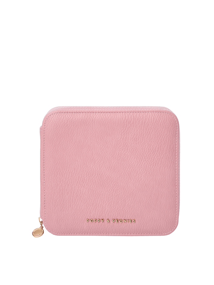 Poppy and Peonies The Out of Office Case Rosé featuring a compact square silhouette, textured soft pink exterior, rounded corners, gold-tone zipper closure with round zipper pull, and gold Poppy and Peonies logo near the bottom.
