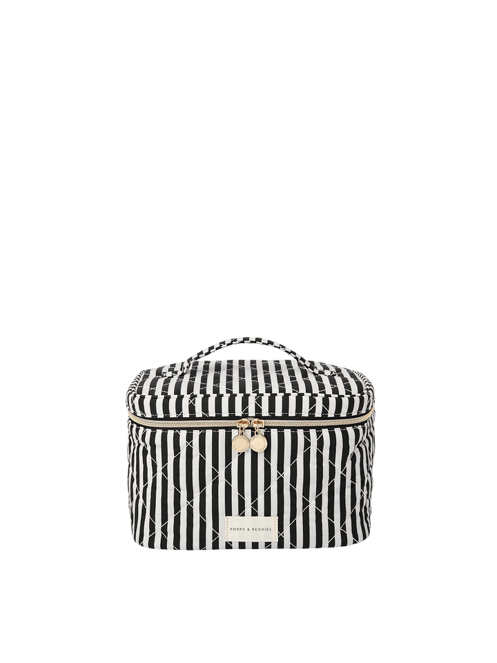 Poppy and Peonies Travel Trio Black Stripe featuring the large travel case with a black and white striped exterior, structured rectangular silhouette, top carrying handle, zip-around closure, and rectangular Poppy and Peonies logo plate on the front.