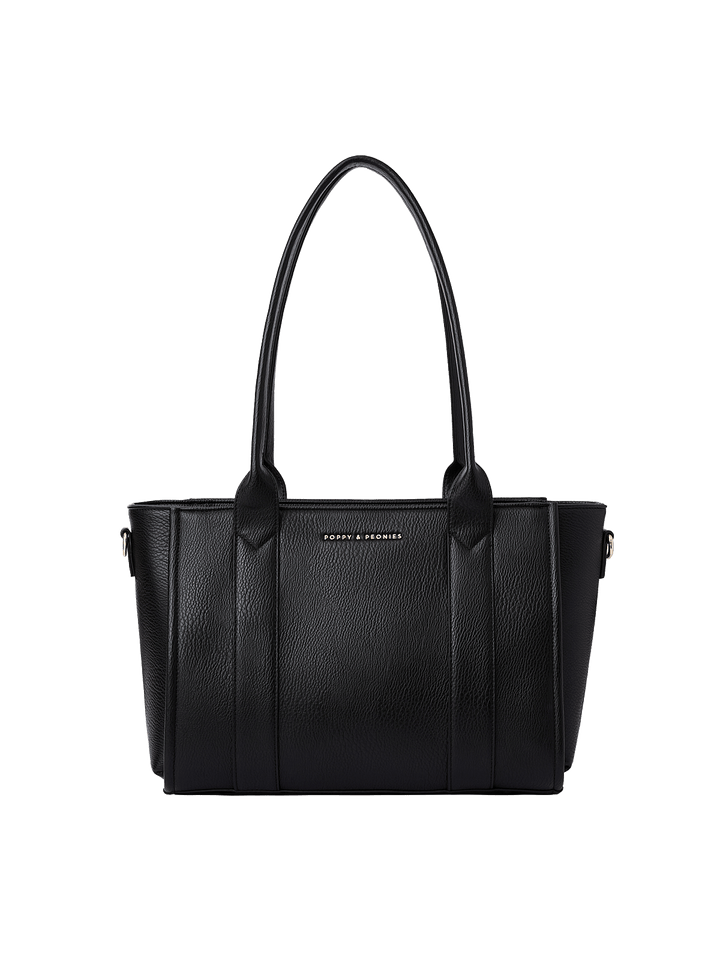 Poppy and Peonies Small Multitasker Black displayed from the front without the shoulder strap, showcasing its textured black exterior, structured rectangular silhouette, dual shoulder handles, vertical seam detailing, and subtle front logo.