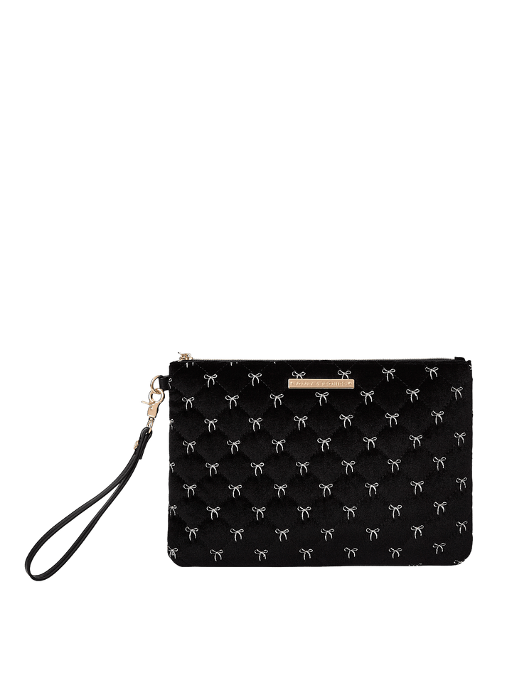 Poppy and Peonies The Clutch Trio Black Velvet featuring the large black velvet clutch with delicate white bow patterns, a rectangular silhouette, gold-tone zipper closure, front logo plate, and detachable black wristlet strap.