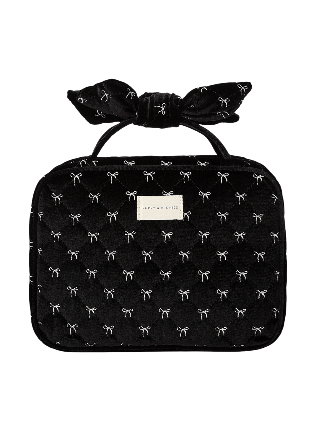Poppy and Peonies Hook Me Up Cosmetic Case Black Velvet featuring a structured rectangular silhouette, soft black velvet exterior with delicate white bow patterns, decorative bow-shaped top handle, zip-around closure, and rectangular gold Poppy and Peonies logo plate on the front.