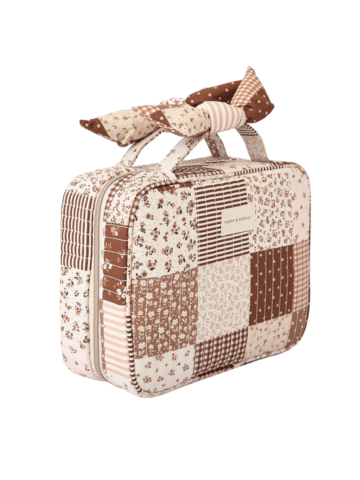 Angled side view of Small Hook Me Up Cosmetic Case in Brown Patchwork