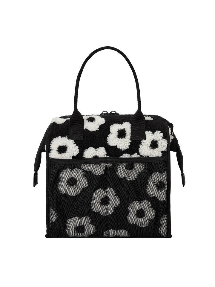 Poppy and Peonies The Lunch Bag Black Floral displayed from the back, featuring its black and white floral exterior, structured rectangular shape, dual top handles, and zippered top closure.