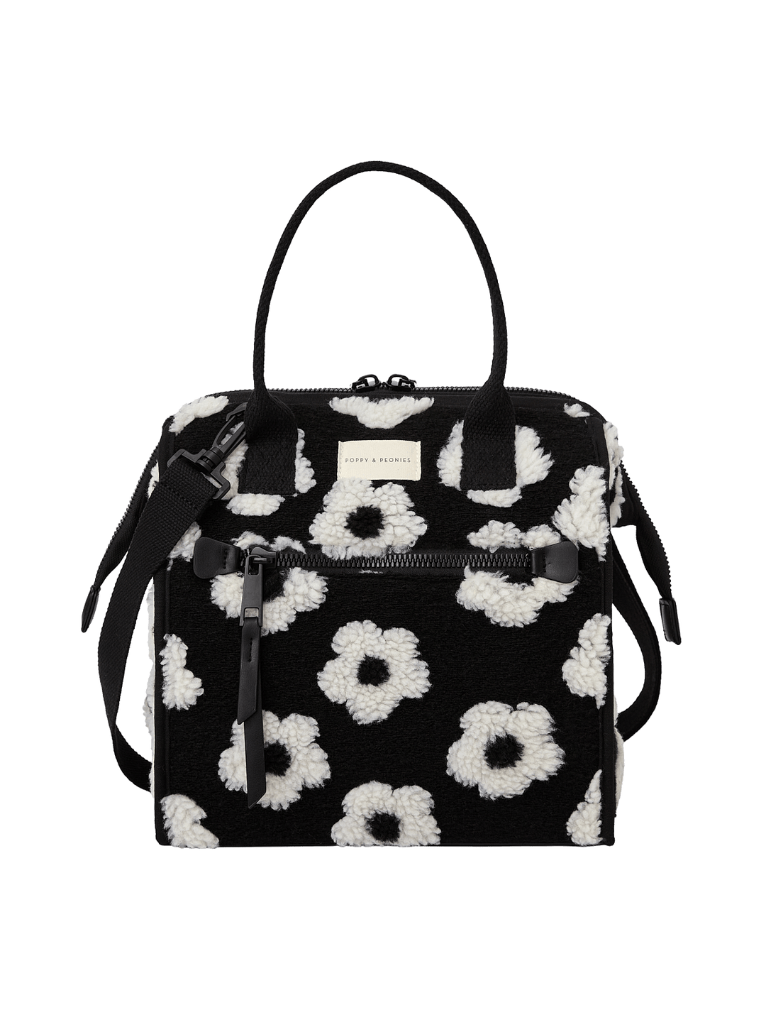 Poppy and Peonies The Lunch Bag Black Floral featuring a structured rectangular silhouette, black exterior with white floral patterns, dual top handles, detachable shoulder strap, gold-tone hardware, and a front logo plate.