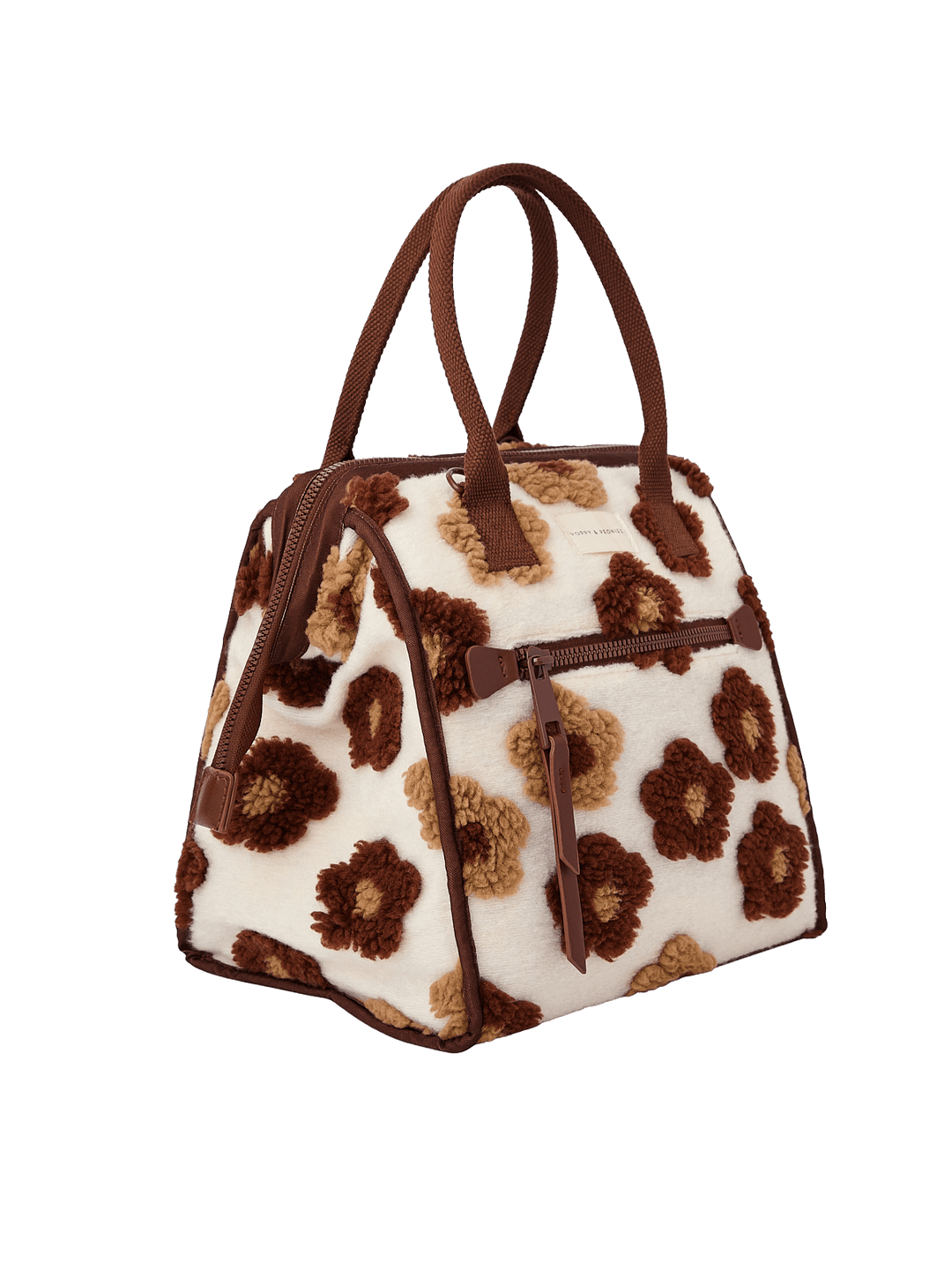Poppy and Peonies The Lunch Bag Espresso Floral displayed at a three-quarter angle, highlighting its structured silhouette, cream-colored exterior with brown and espresso floral patterns, contrasting brown trim, dual top handles, and spacious side profile.