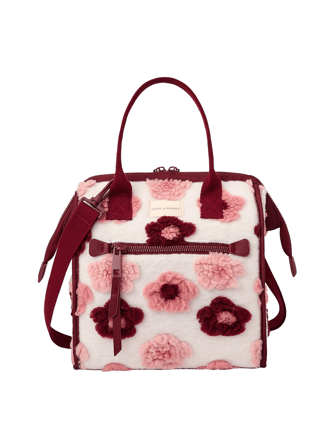 Poppy and Peonies The Lunch Bag Berry Floral featuring a structured rectangular silhouette, cream-colored exterior with pink and berry floral patterns, contrasting berry trim, dual top handles, detachable shoulder strap, gold-tone hardware, and front zippered pocket.