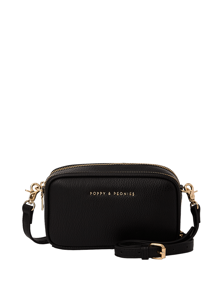 Black crossbody bag with gold accents on a transparent background