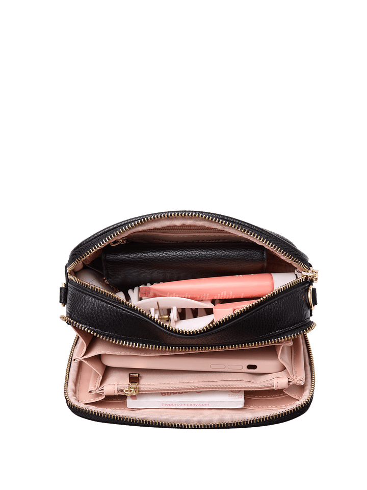 Open handbag with makeup items on a transparent background