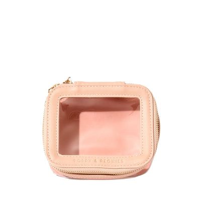 Blush coloured cosmetic case with a clear lid