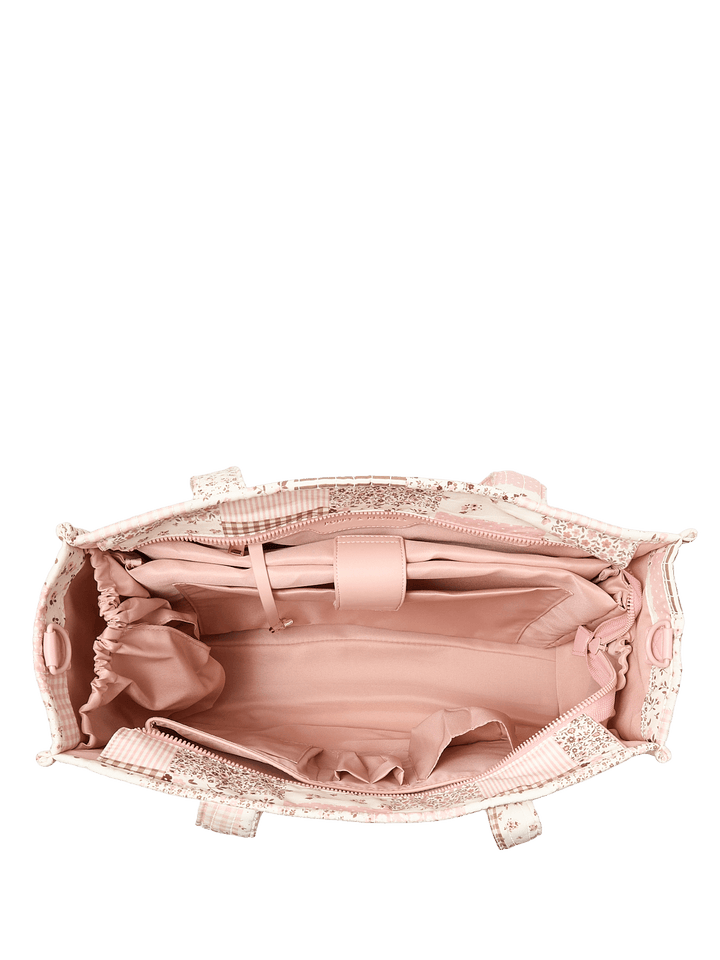 Open patchwork tote bag with floral and plaid patterns and a pink interior