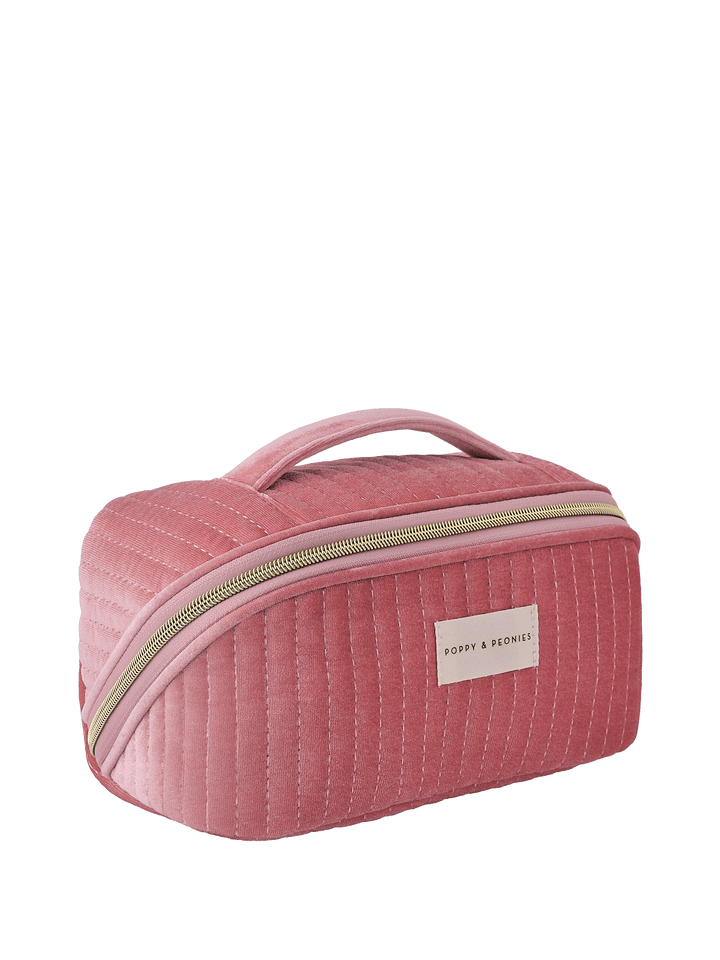 Pink velvet quilted cosmetic bag with a handle