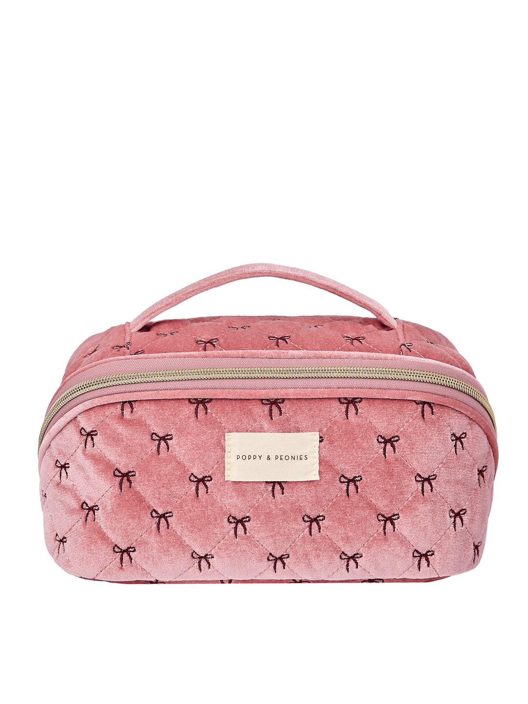 Poppy and Peonies Open and Glow Cosmetic Case Pink Velvet featuring a structured rectangular silhouette, soft pink velvet exterior with delicate black bow patterns, top carrying handle, gold-tone zip-around closure, front zippered pocket, and rectangular gold Poppy and Peonies logo plate.