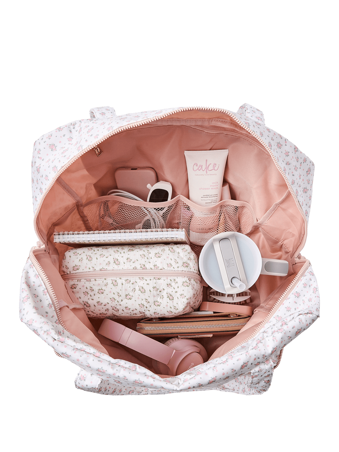 Open floral print duffel bag with items in it