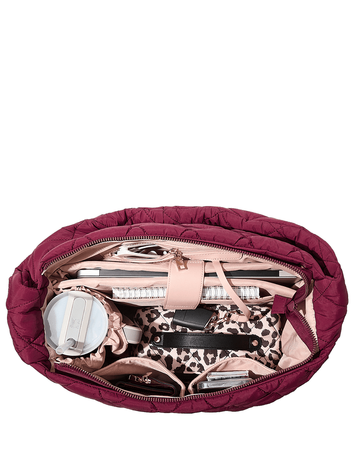 Interior of a berry coloured quilted hobo bag