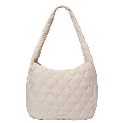 front of a Poppy and Peonies cream coloured quilted hobo style bag