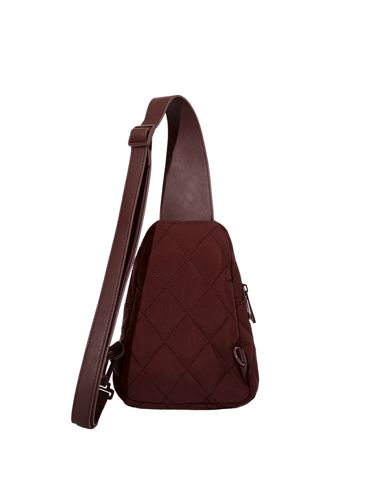 Brown quilted sling bag on a transparent background
