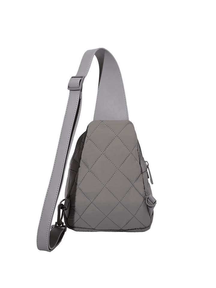 Grey quilted crossbody bag on a transparent background