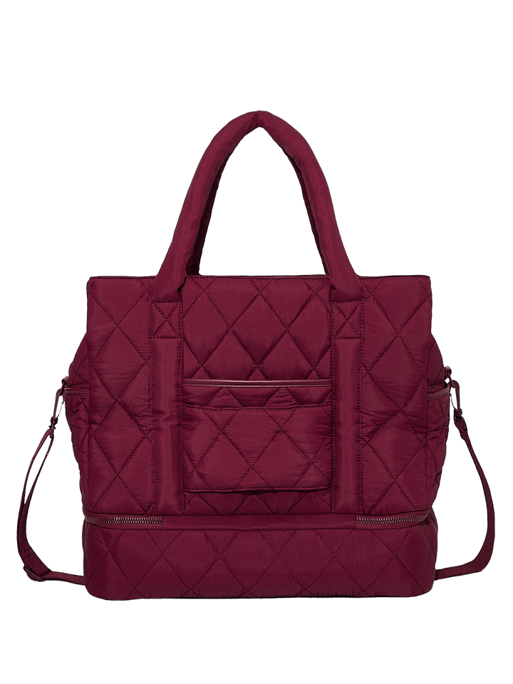 Quilted berry coloured handbag on a transparent background