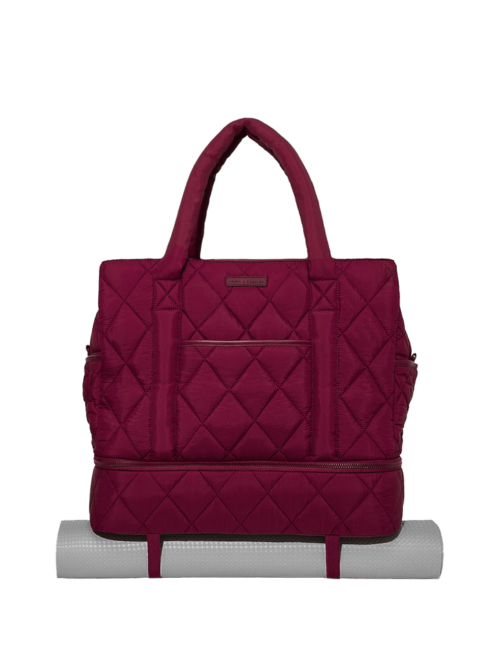 Quilted berry travel bag on a white background
