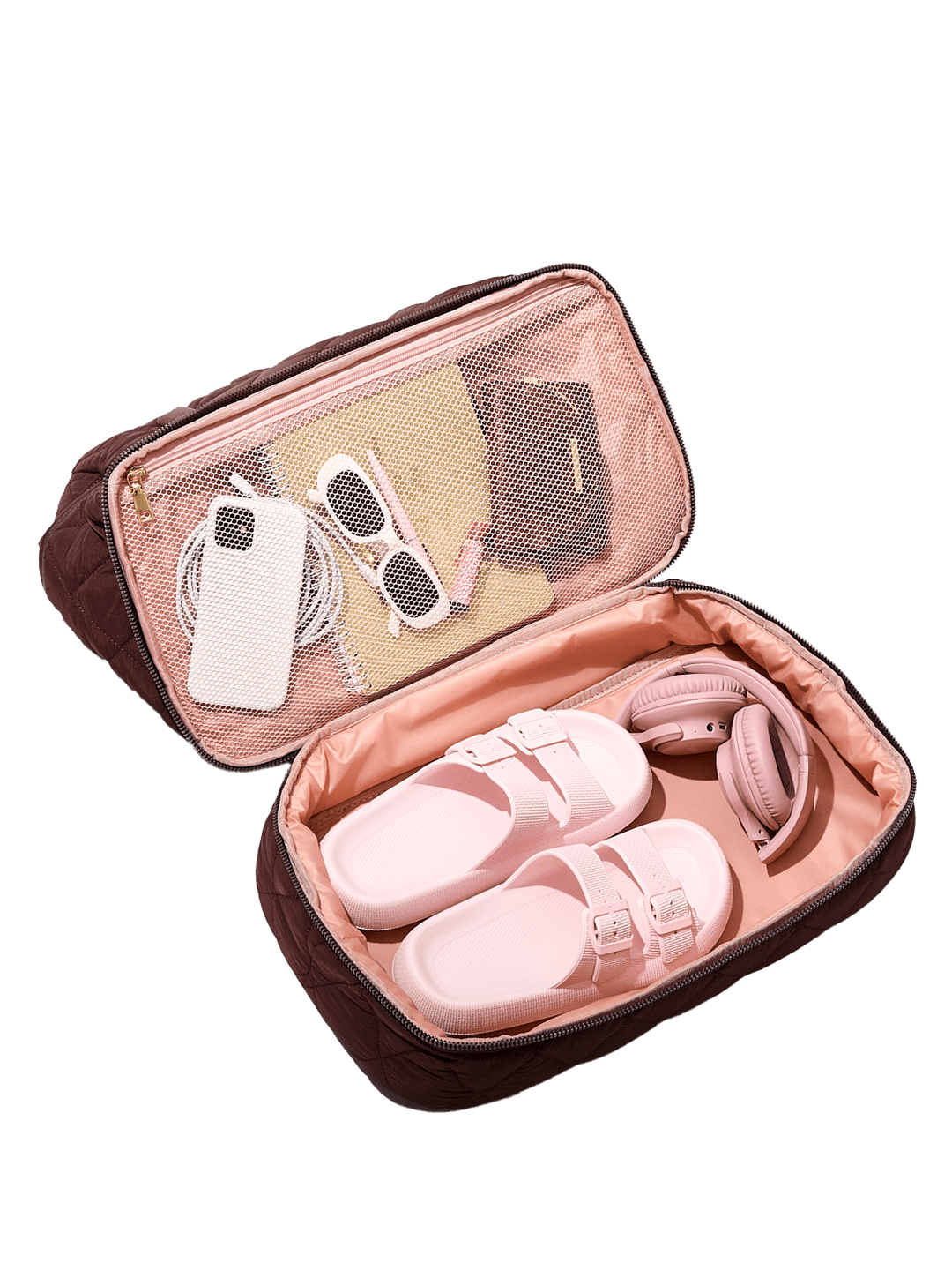 Pink sandals in an open travel pouch with sunglasses and shoes