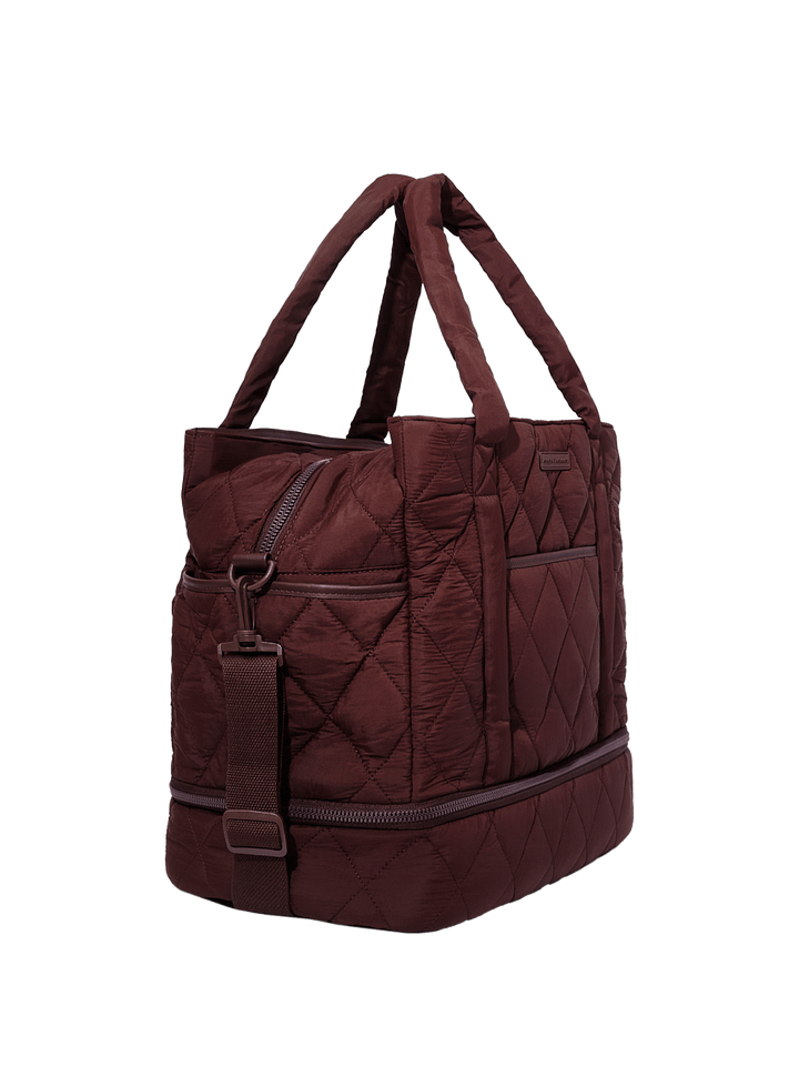Quilted brown handbag on a transparent background