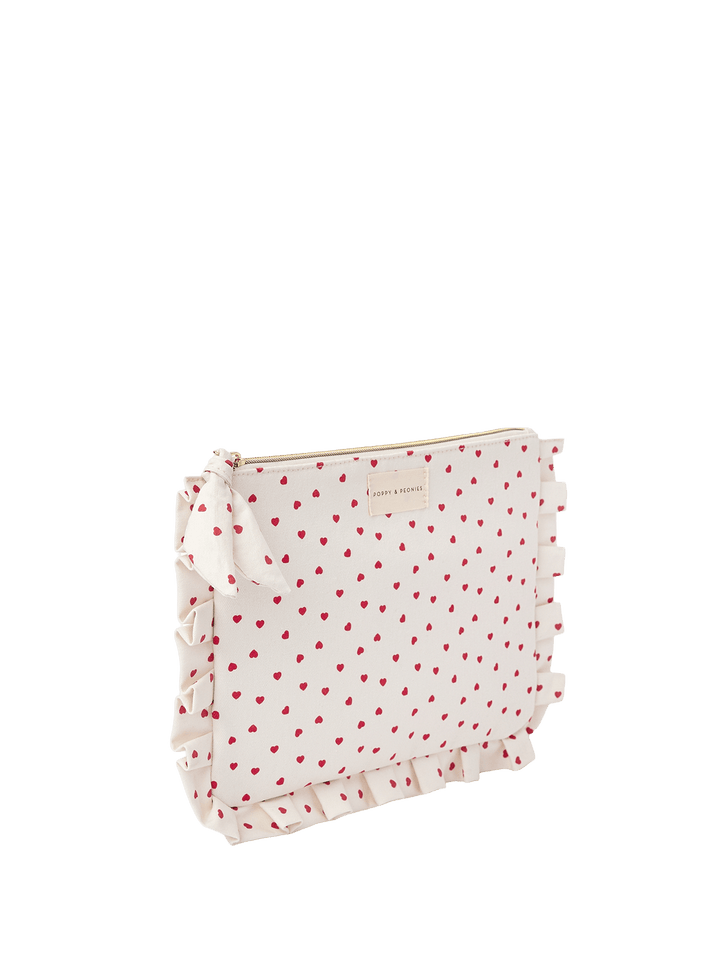 White clutch with red heart pattern
