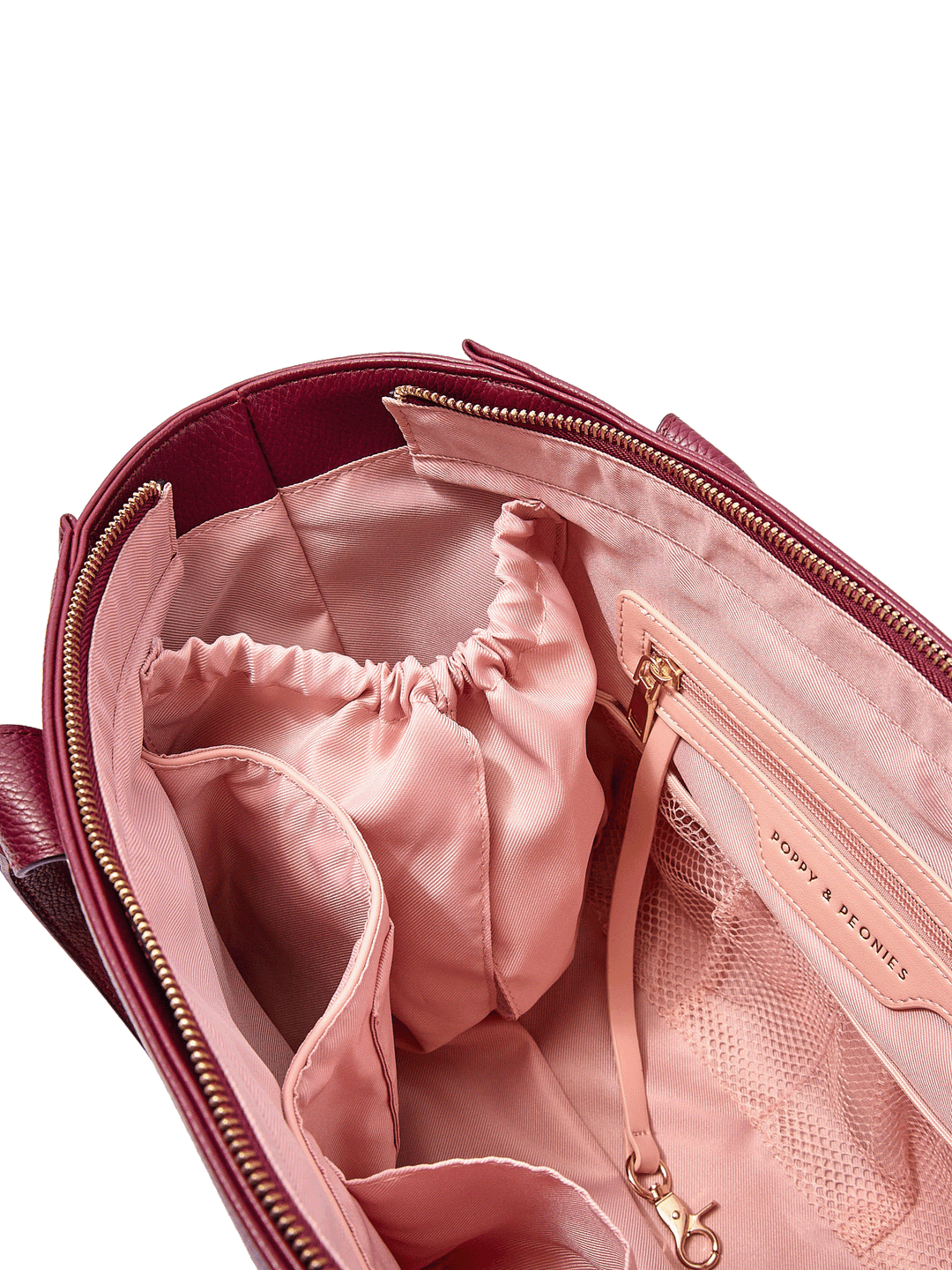 Close-up of the Small Multitasker in Berry showing cup holder, key leash, and organization pockets