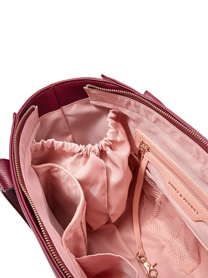 Close-up of the Small Multitasker in Berry showing cup holder, key leash, and organization pockets