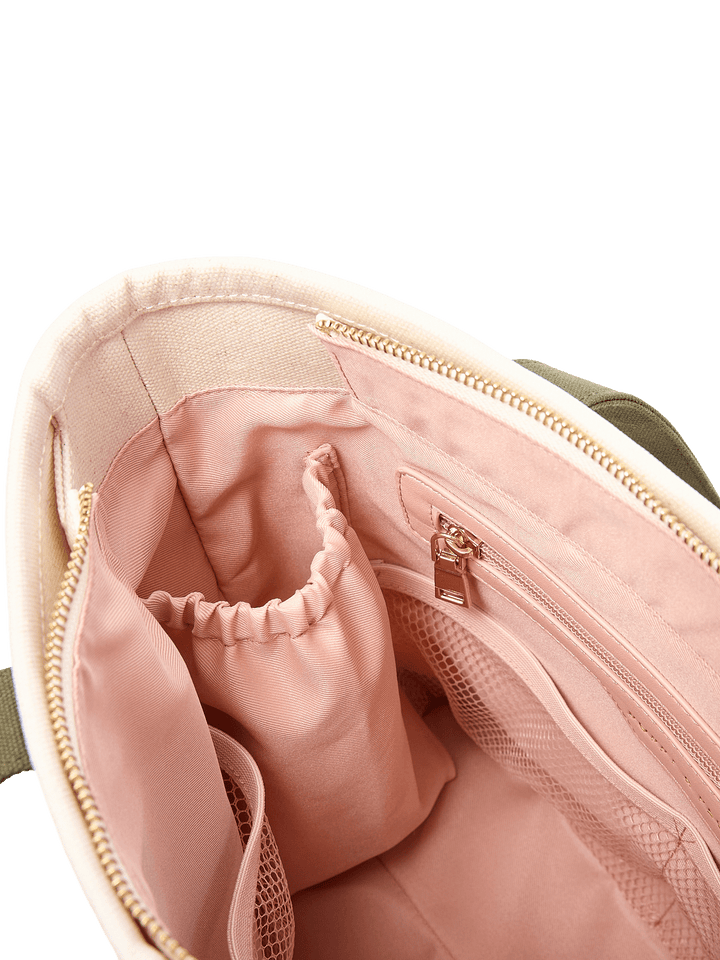 Poppy & Peonies The Small Signature Tote in Olive, close-up of the blush-pink interior featuring gathered elastic pockets, a zippered compartment, and mesh organizer pocket.