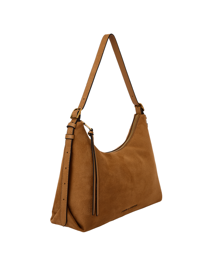 Poppy & Peonies The Sunday Bag in Cognac Suede angled side view, highlighting the soft hobo silhouette, adjustable shoulder strap and tassel detail.