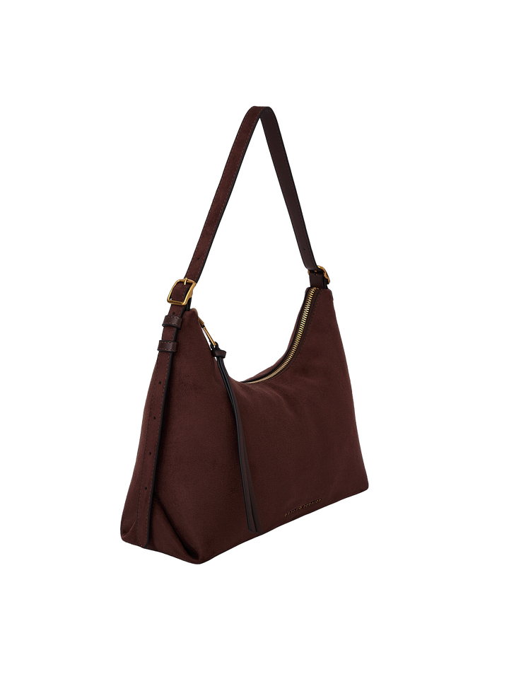 Poppy & Peonies The Sunday Bag in Cognac Suede angled side view, highlighting the soft hobo silhouette, adjustable shoulder strap and tassel detail.