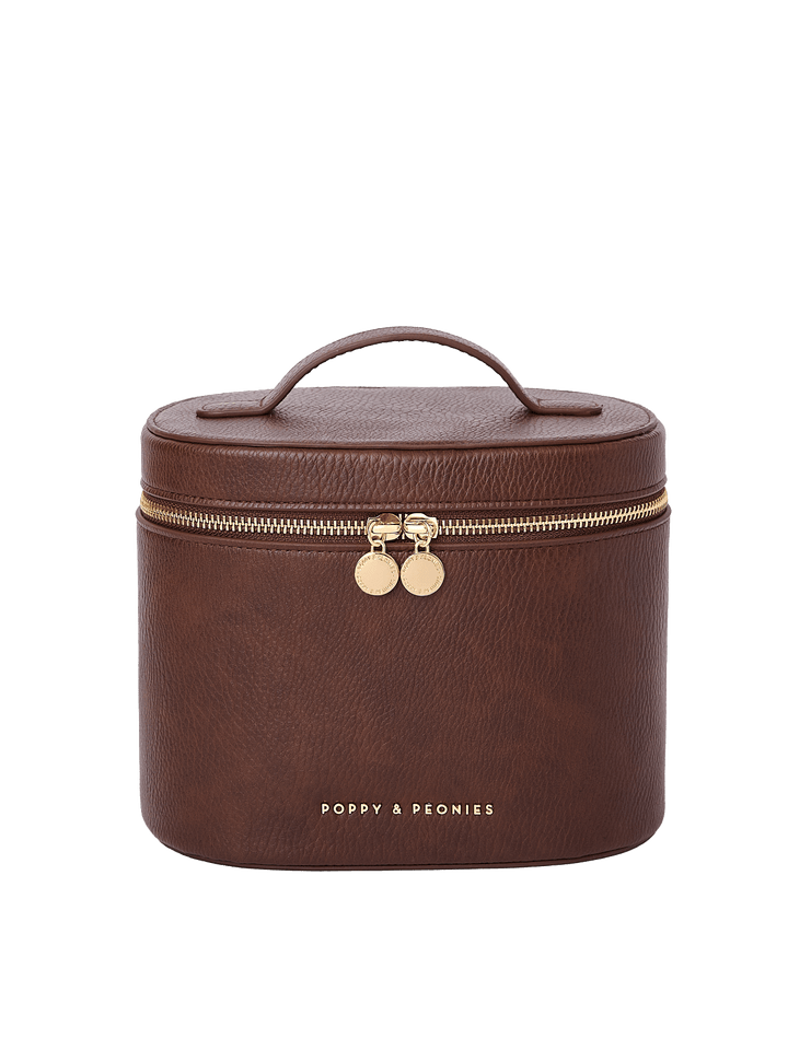 Poppy and Peonies The Vanity Case Espressso featuring a structured rounded rectangular silhouette, textured espresso exterior, top carrying handle, gold-tone zip-around closure with double round zipper pulls, and gold Poppy and Peonies logo on the front.