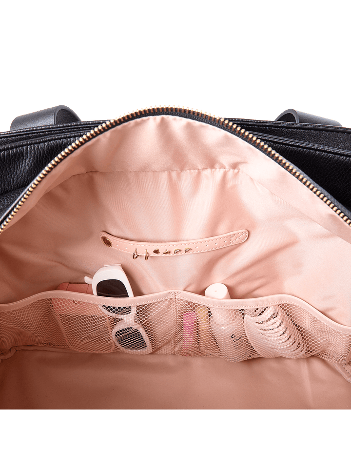 Interior slide pocket and jewelry tab inside Mini Voyager tote in Black 