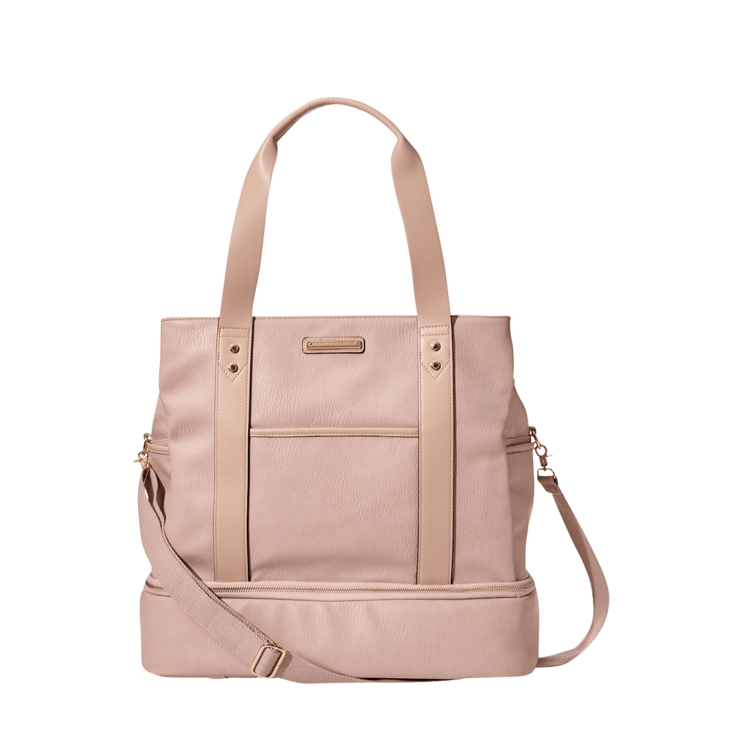 Blush coloured vegan leather travel bag with a shoulder strap and a crossbody strap