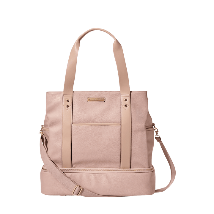 Blush coloured vegan leather travel bag with a shoulder strap and a crossbody strap