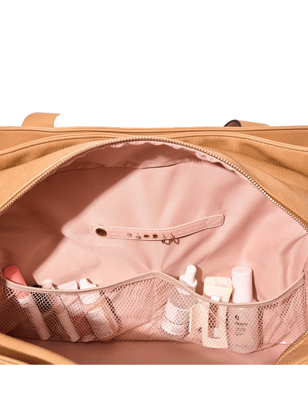 Open vegan leather bag with pink interior showing toiletries and a mesh pocket.
