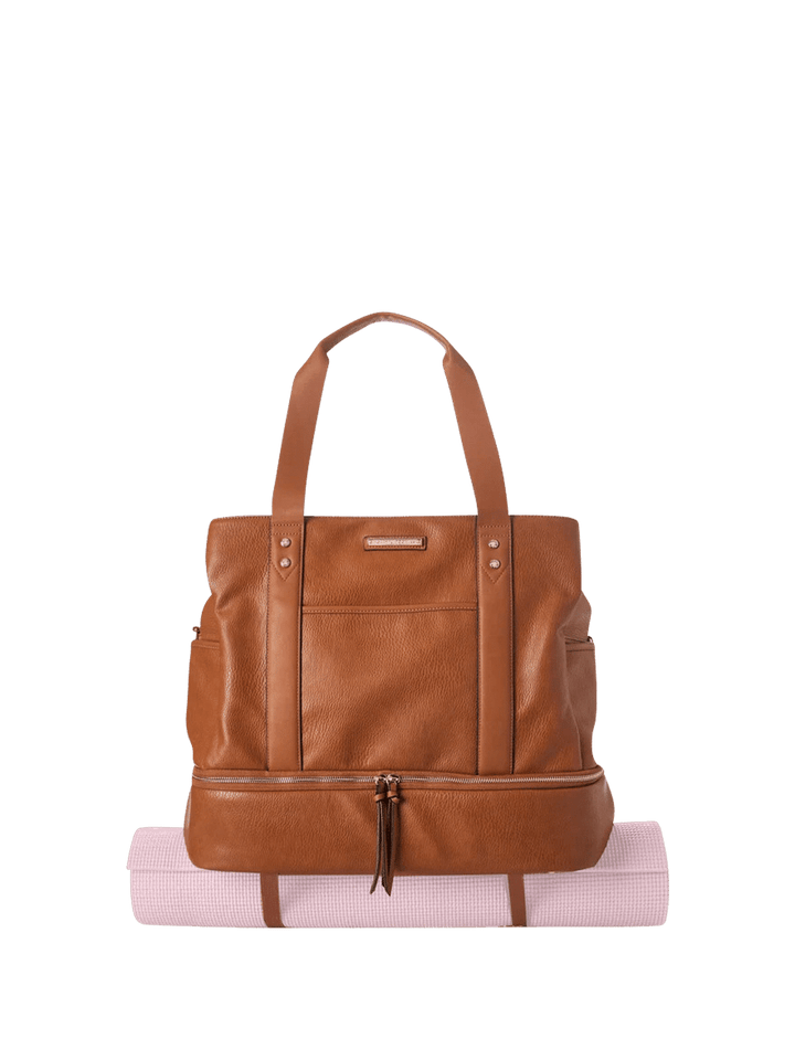 Brown vegan leather bag with a yoga strap attached to the bottom