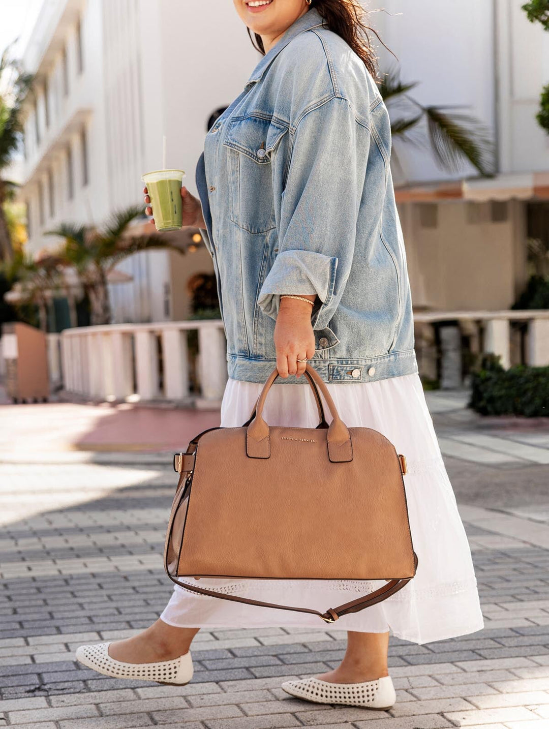 Woman holding a mocha mousse totebag on a sidewalk